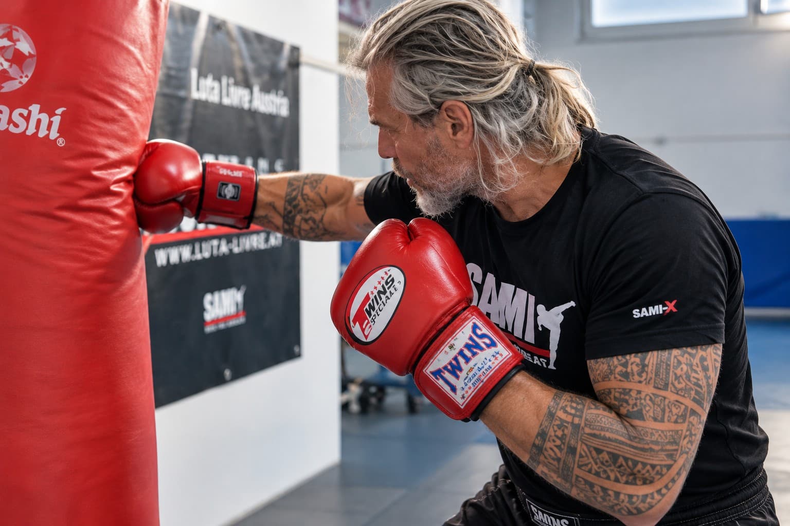 A boxer practices a controlled straight punch on a heavy bag.